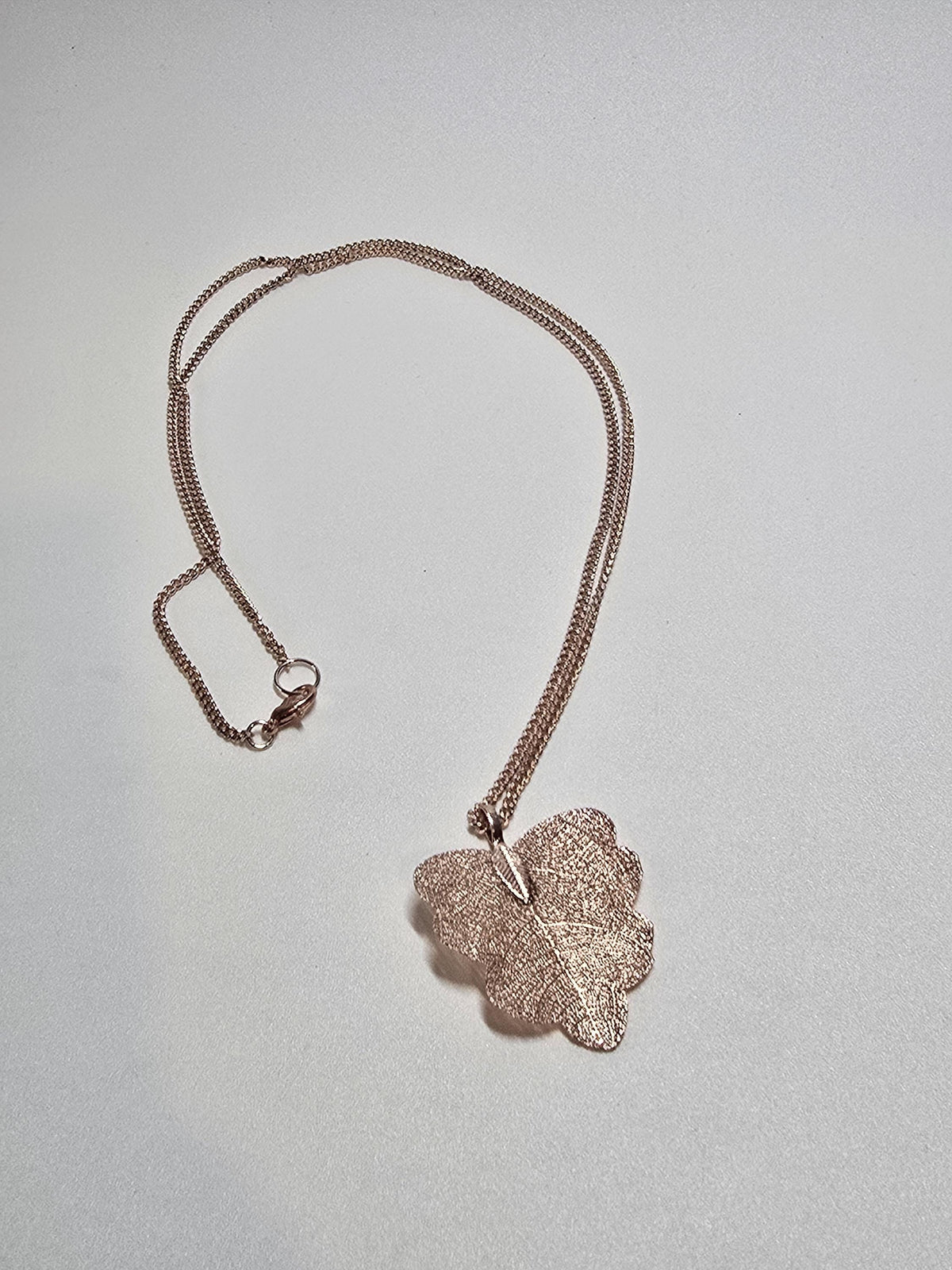 Close-up of gold textured leaf pendant
